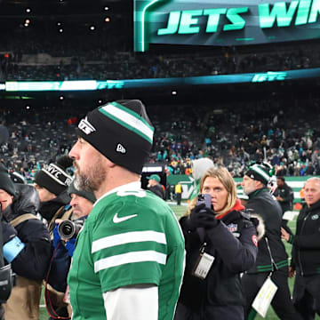 Jan 5, 2025; East Rutherford, New Jersey, USA; New York Jets quarterback Aaron Rodgers (8) walks on the field after the Jets win over the Miami Dolphins at MetLife Stadium. Mandatory Credit: Ed Mulholland-Imagn Images