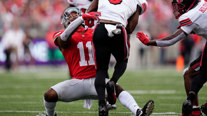 Sep 16, 2023; Columbus, Ohio, USA; Ohio State Buckeyes linebacker C.J. Hicks (11) tackles Western Kentucky Hilltoppers running back Elijah Young (3) on a kickoff during the NCAA football game at Ohio Stadium. Ohio State won 63-10.