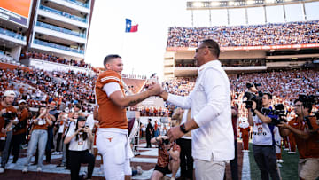 Texas Longhorns head coach Steve Sarkisian embraces quarterback Quinn Ewers as Ewers