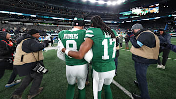 Jan 5, 2025; East Rutherford, New Jersey, USA; New York Jets quarterback Aaron Rodgers (8) and wide receiver Davante Adams (17) walk on the field after the Jets win over the Miami Dolphins at MetLife Stadium. Mandatory Credit: Ed Mulholland-Imagn Images
