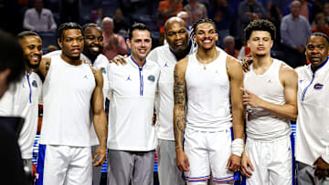 Florida Gators seniors Alijah Martin, Will Richard and Walter Clayton Jr. pose with coaches Taurean Green, Todd Golden, Carlin Hartman and Korey McCray during the Senior Night ceremony.