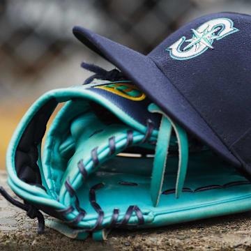 A Seattle Mariners hat and glove sits in dugout during a game against the Detroit Tigers on May 12, 2018, at Comerica Park.