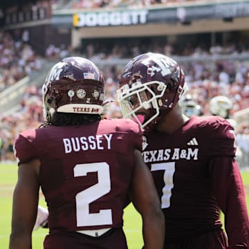 Texas A&M Aggies' Terry Bussey (2) and Moose Muhammad III (7) talk on the field against the Missouri Tigers at Kyle Field. 
