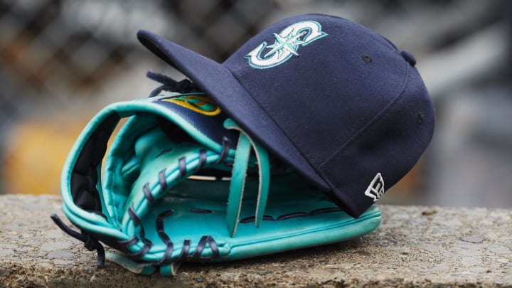 A Seattle Mariners hat and glove sits in dugout during the third inning of a game against the Detroit Tigers in 2018.