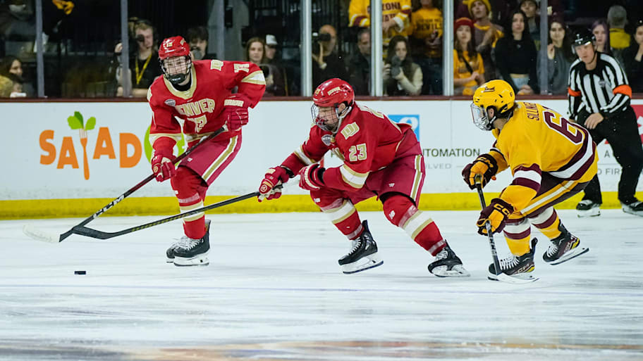 Hagen Burrows (left) and Eric Pohlkamp (right) navigate the puck for Denver against Arizona State.