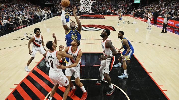 Apr 11, 2024; Portland, Oregon, USA; Golden State Warriors forward Kevon Looney (5) puts up a shot during the second half against Portland Trail Blazers center Deandre Ayton (2) at Moda Center. Mandatory Credit: Troy Wayrynen-USA TODAY Sports