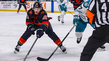 Coachella Valley forward Tucker Robertson (32) works to keep the puck away from San Jose defenseman Valtteri Pulli (77) during the first period of their game at Acrisure Arena in Palm Desert, Calif., Thursday, April 4, 2024.