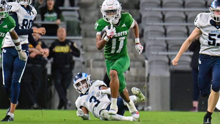 Lincoln's Isaiah Grant sprints away from defenders in last season's Open Division championship game. Grant entered Friday's regular closing game — a 56-0 win over Madison — with 18 catches for 266 yards. 