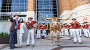 Sean Miller and his wife, Amy Miller, pose with Bevo as The University of Texas announces Miller as their new men's basketball coach Tuesday, March 25, 2025.