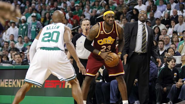 Cleveland Cavaliers head coach Mike Brown (right) reacts from the sideline as forward LeBron James (23)