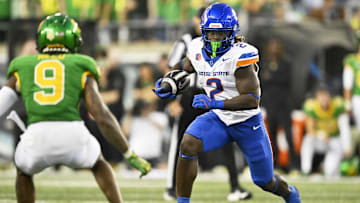 Sep 7, 2024; Eugene, Oregon, USA; Boise State Broncos running back Ashton Jeanty (2) rushes for a first down during the first half against Oregon Ducks defensive back Nikko Reed (9) at Autzen Stadium. Mandatory Credit: Troy Wayrynen-Imagn Images