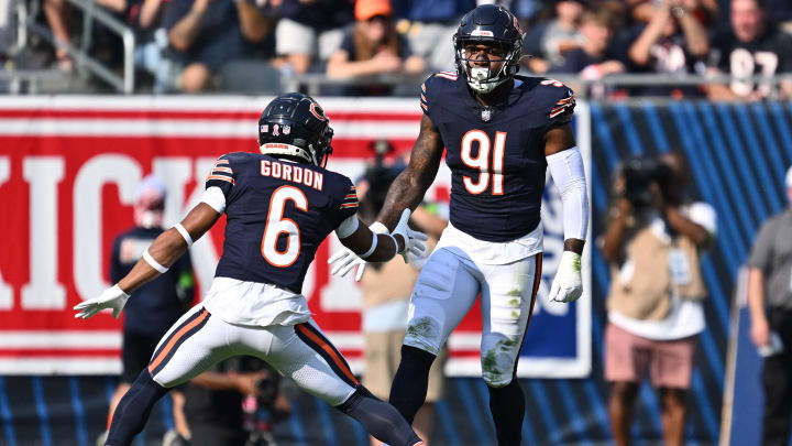 Sep 10, 2023; Chicago, Illinois, USA;  Chicago Bears defensive lineman Yannick Ngakoue (91) celebrates with defensive back Kyler Gordon (6) after dropping the Green Bay Packers ballcarrier for a loss in the first half at Soldier Field.