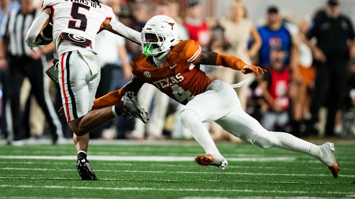 Oct 19, 2024; Austin, Texas, USA; Texas Longhorns defensive back Andrew Mukuba (4) tackles Georgia Bulldogs wide receiver Anthony Evans III (5) in the second quarter at Darrell K. Royal Texas Memorial Stadium. Mandatory Credit: Sara Diggins/USA TODAY Network via Imagn Images