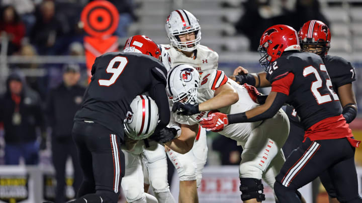 Zahir Mathis of Imhotep Charter (No. 9) makes a tackle against Peters Township in the 2023 PIAA Class 5A state championship gam.e 