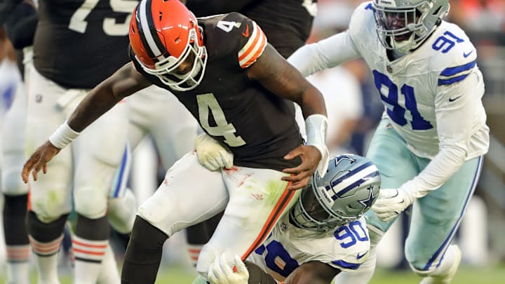 Cleveland Browns quarterback Deshaun Watson (4) fumbles the ball as he is tackled by Dallas Cowboys defensive end DeMarcus Lawrence (90) during the second half of an NFL football game at Huntington Bank Field, Sunday, Sept. 8, 2024, in Cleveland, Ohio.