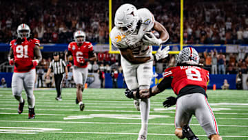 Texas Longhorns running back Jaydon Blue runs around defense from Ohio State Buckeyes safety Lathan Ransom to score a touchdown in the third quarter as the Texas Longhorns play the Ohio State Buckeyes in the Cotton Bowl.