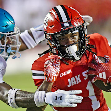 Jacksonville State's Demarcus Lacey tries to evade the tackle of Coastal Carolina's Courtney Eubanks during college football action at Burgess-Snow Field AmFirst Stadium in Jacksonville, Alabama August 29, 2024. (Dave Hyatt / Special to the Gadsden Times)