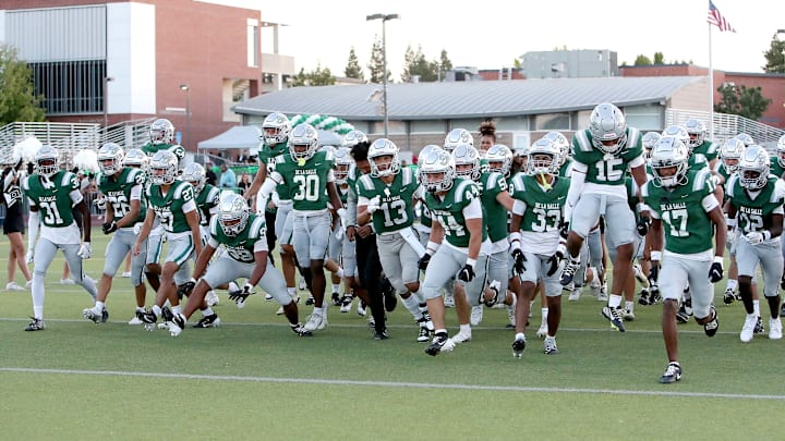 De La Salle players rush the field before the kick off against visiting Grant Union. On Tuesday, the Spartans played overseas for the first time, beating a NFL Academy squad 31-9 in London's tottenham Hotspur Stadium. | Photo: Dennis Lee