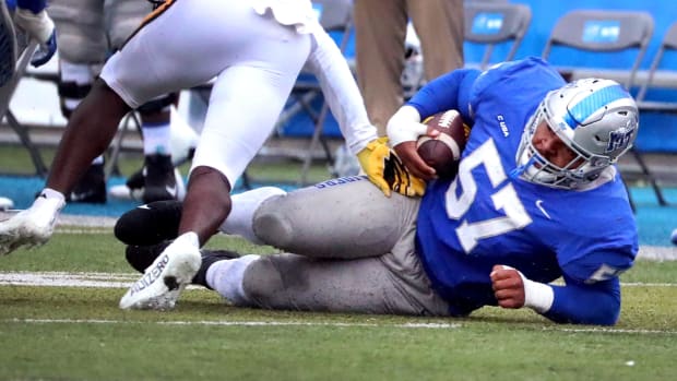 MTSU defensive tackle Marley Cook (57) falls to the ground after intercepting a pass and running the ball against Southern Mi