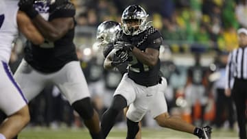 Nov 30, 2024; Eugene, Oregon, USA; Oregon Ducks running back Da'Jaun Riggs (21) carries the ball during the second half against the Washington Huskies at Autzen Stadium. Mandatory Credit: Troy Wayrynen-Imagn Images