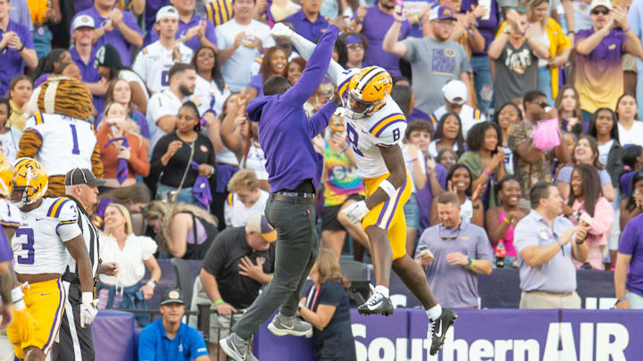 LSU WR Malik Nabers 8 celebrates with Receivers Coach Cortez Hankton after a touchdown as the LSU Tigers take on the Auburn Tigers at Tiger Stadium in Baton Rouge, Louisiana, Saturday, Oct. 14, 2023.