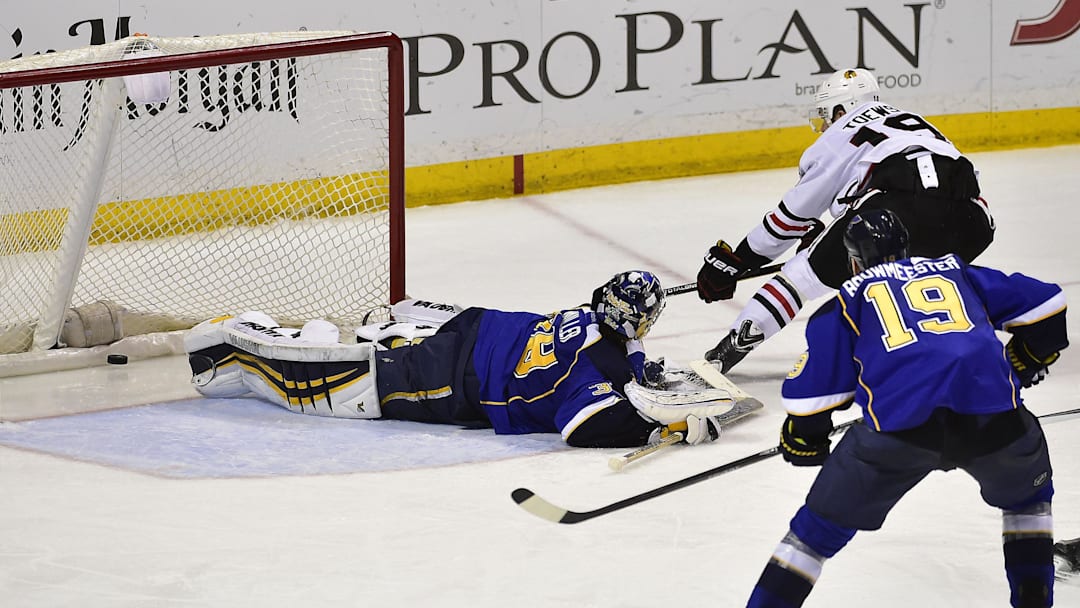 Apr 25, 2014; St. Louis, MO, USA; Chicago Blackhawks center Jonathan Toews (19) shoots and scores the game winning goal against St. Louis Blues goalie Ryan Miller (39) during overtime in game five of the first round of the 2014 Stanley Cup Playoffs at Scottrade Center. The Blackhawks defeated the Blues 3-2. Mandatory Credit: Scott Rovak-Imagn Images