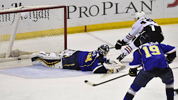 Apr 25, 2014; St. Louis, MO, USA; Chicago Blackhawks center Jonathan Toews (19) shoots and scores the game winning goal against St. Louis Blues goalie Ryan Miller (39) during overtime in game five of the first round of the 2014 Stanley Cup Playoffs at Scottrade Center. The Blackhawks defeated the Blues 3-2. Mandatory Credit: Scott Rovak-Imagn Images