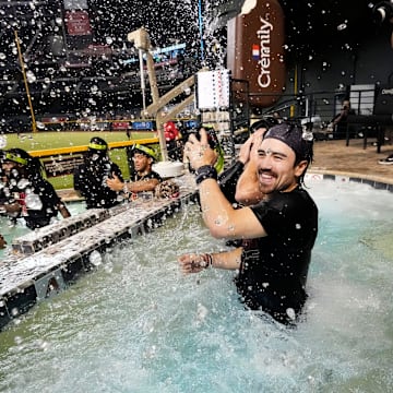 Arizona Diamondbacks Corbin Carroll splashes his teammates in the outfield pool during post-game celebrations after clinching a wild card playoff spot following their game with the Houston Astros at Chase Field on Sept 30, 2023.