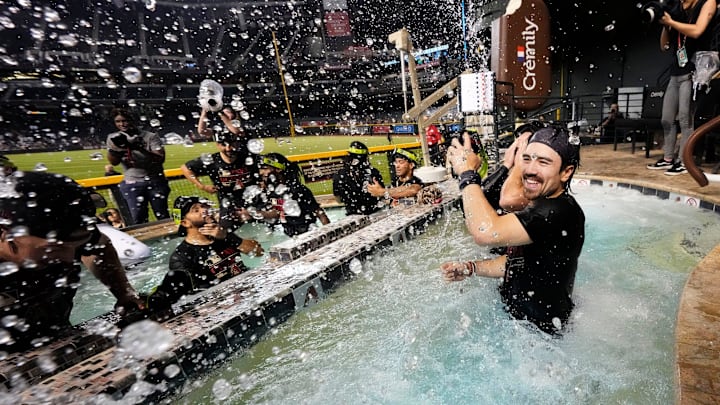 Arizona Diamondbacks Corbin Carroll splashes his teammates in the outfield pool during post-game celebrations after clinching a wild card playoff spot following their game with the Houston Astros at Chase Field on Sept 30, 2023.