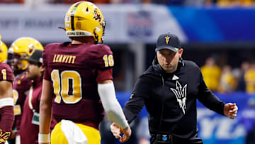 Head coach Kenny Dillingham of the Arizona State Sun Devils shakes hands with Sam Leavitt #10 as he walks off the field during the third quarter against the Texas Longhorns in the Chick-fil-A Peach Bowl at Mercedes-Benz Stadium on January 01, 2025 in Atlanta, Georgia.