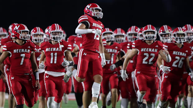 Wisconsin high school football: Neenah runs onto the field before a Fox Valley Association game versus Neenah. 2025
