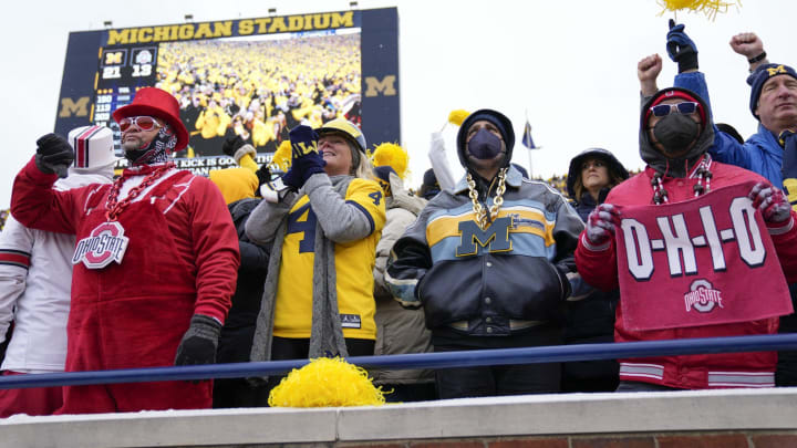 Ohio State Buckeyes and Michigan Wolverines fans react to a Hassan Haskins touchdown during the third quarter of the NCAA football game at Michigan Stadium in Ann Arbor on Saturday, Nov. 27, 2021.