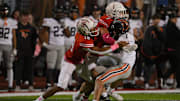Ryan Petras #1 of the Bethel Park Black Hawks is wrapped up for a tackle by Jared Moyer #18 and Nicolas Prozzoly #1 of the Moon Tigers in the first half during the game at Tiger Stadium on Friday Night in Moon Township, Pennsylvania.