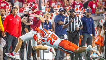 Indiana's Fernando Mendoza (15) is pushed by Illinois' Dylan Rosiek (28) as he runs during the Indiana versus Illinois football game at Memorial Stadium on Saturday, Sept. 20, 2025