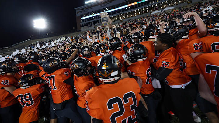 Platte County players hoist the championship trophy while celebrating their victory over Helias Catholic in Missouri Class 5 state title game. Platte County players hoist the championship trophy while celebrating their victory over Helias Catholic in Missouri Class 5 state title game.