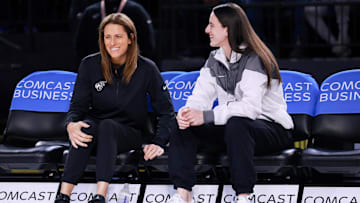 Indiana Fever guard Caitlin Clark talks with head coach Stephanie White before the game against the Washington Mystics. 