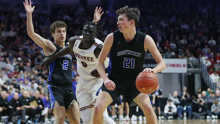 Waukee Northwest guard Pryce Sandfort (21) attempts to drive around Waukee forward Omaha Biliew (0) during the first quarter in the class 4A boys state basketball semi-final at Wells Fargo Arena Thursday, March 9, 2023, in Des Moines, Iowa.