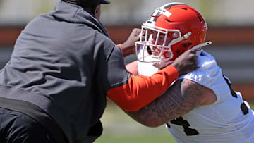 Cleveland Browns defensive tackle Mason Graham (94) works with defensive line coach Jacques Cesaire during NFL rookie minicamp at the Cleveland Browns training facility.