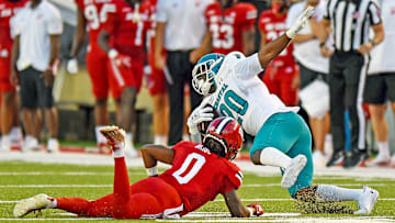 Coastal Carolina's Christian Washington tries to evade the tackle of Jacksonville State's Tyler Bride. 