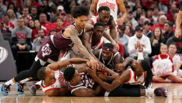 Nov 10, 2023; Columbus, Ohio, USA; Ohio State Buckeyes and Texas A&M Aggies players dive on a loose ball during the first half of the NCAA basketball game at Value City Arena.