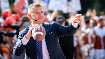 Analysts Kirk Herbstreit tosses the football with fans on the set of ESPN's College Game Day at the University of Texas, ahead of the Longhorns' game against the Georgia Bulldogs in Austin, Oct. 19, 2024.