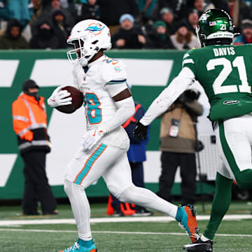 Miami Dolphins running back De'Von Achane (28) scores a touchdown during the fourth quarter of their game against the New York Jets at MetLife Stadium in the 2024 season finale.