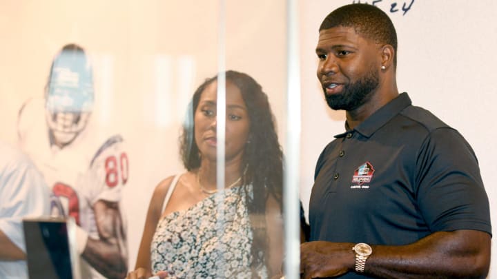 Devin Hester and his wife, Zingha, look at his memorabila in Canton during a May visit to the Pro Football Hall of Fame.