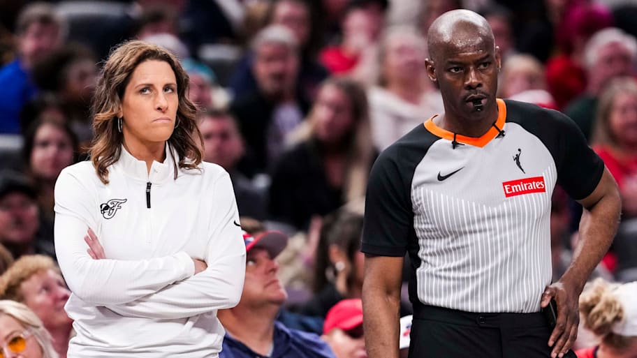 Indiana Fever head coach Stephanie White stands next to an official during the game | Grace Smith/IndyStar / USA TODAY NETWORK via Imagn Images