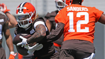Cleveland Browns running back Quinshon Judkins (10) takes a handoff from quarterback Shedeur Sanders (12) during NFL rookie minicamp at the Cleveland Browns training facility on Friday, May 9, 2025, in Berea, Ohio.