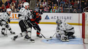 Coachella Valley forward Cameron Hughes (19) looks for a shot on Ontario goaltender Erik Portillo (1) as defenseman Kevin Connauton (44) checks him into the net during the first period of Game 2 of the Pacific Division Finals at Acrisure Arena in Palm Desert, Calif., Friday, May 17, 2024.