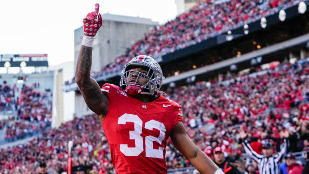 Ohio State Buckeyes running back TreVeyon Henderson celebrates a touchdown during a college football game in the Big Ten.