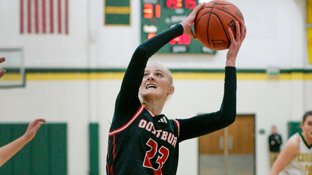 Oostburg’s Kinsley Ketterhagen (23) aims for the basket near Sheboygan Lutheran’s Megan Walz (5) at Lutheran, Tuesday, January 7, 2025, in Sheboygan, Wis.