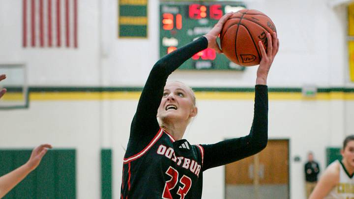 Oostburg’s Kinsley Ketterhagen (23) aims for the basket near Sheboygan Lutheran’s Megan Walz (5) at Lutheran, Tuesday, January 7, 2025, in Sheboygan, Wis.