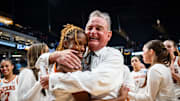 Texas Longhorns head coach Vic Schaefer embraces guard Bryanna Preston (1) after winning the NCAA Playoff Regional semi-final game against the Tennessee Lady Vols 59-67 at Legacy Arena in Birmingham Alabama, March 29, 2025. The Longhorns will advance to the Elite Eight round, playing against TCU in the Regional Finals on Monday.